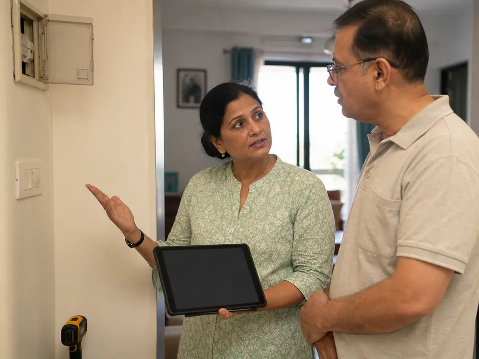 Indian property inspector explaining findings to a homeowner